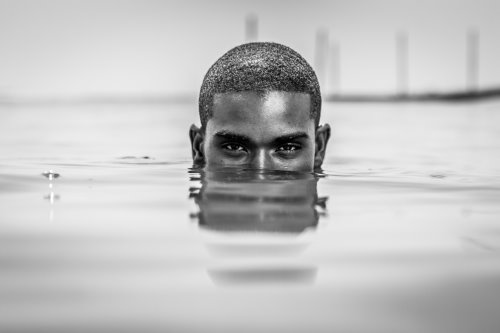 Head of a man partially submerged in water