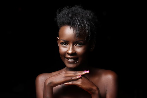 A woman in front of a black background